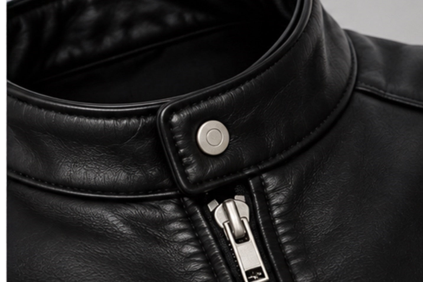 Men’s black leather jacket snap-tab collar and zipper details