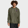 Model wearing an olive-green New England Patriots hoodie with black pants on a light gray background.